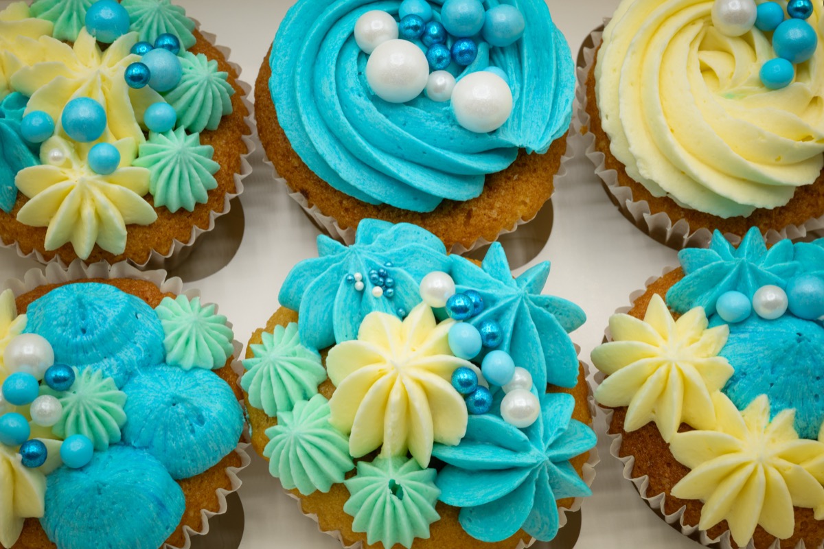 A box of beautifully decorated cupcakes